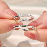 Close-up of fingers holding pavé bamboo ring and plain bamboo ring in white gold